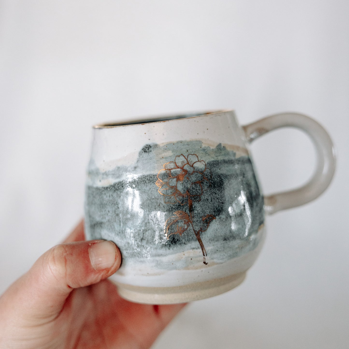 Teal and White Pottery Mug with a Gold Flower Decal