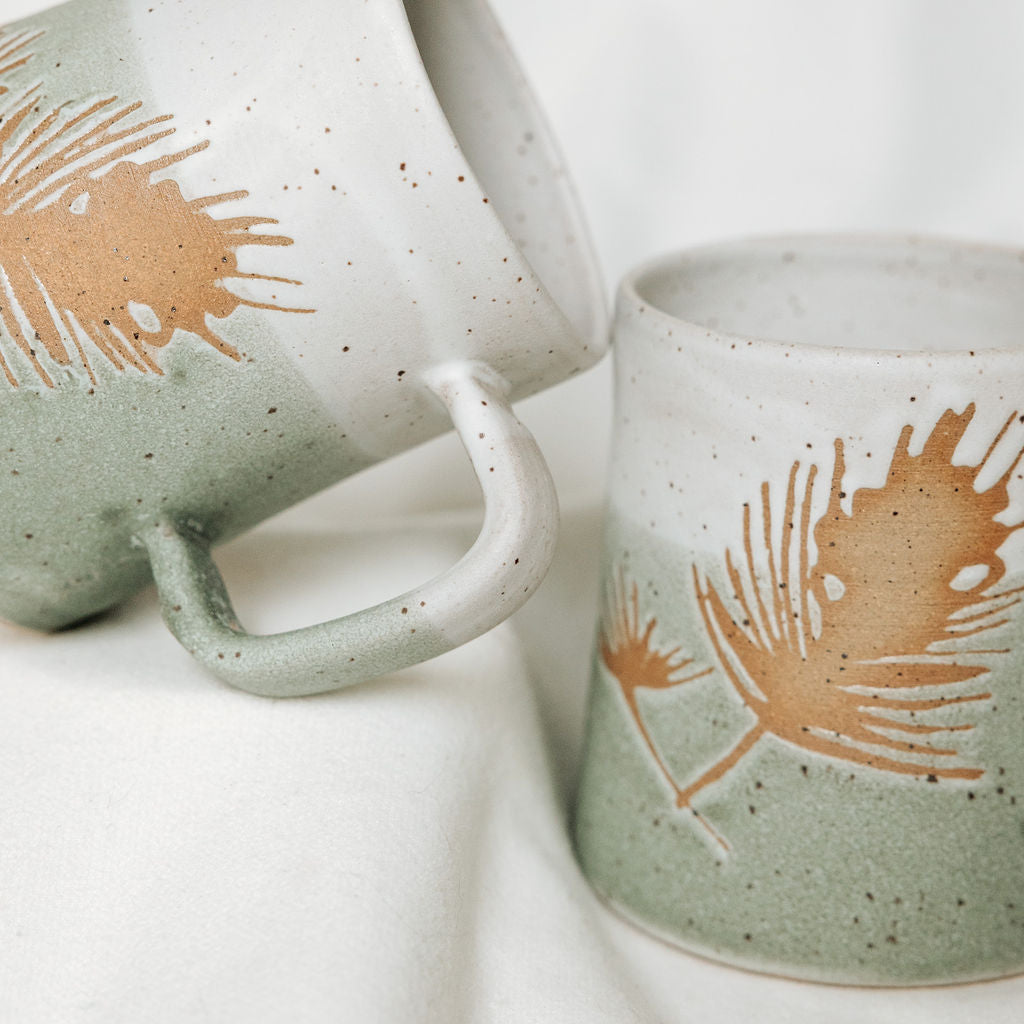 Winter Pine Boughs Mug in Black, Deep Evergreen, and Sand and Sage Glaze