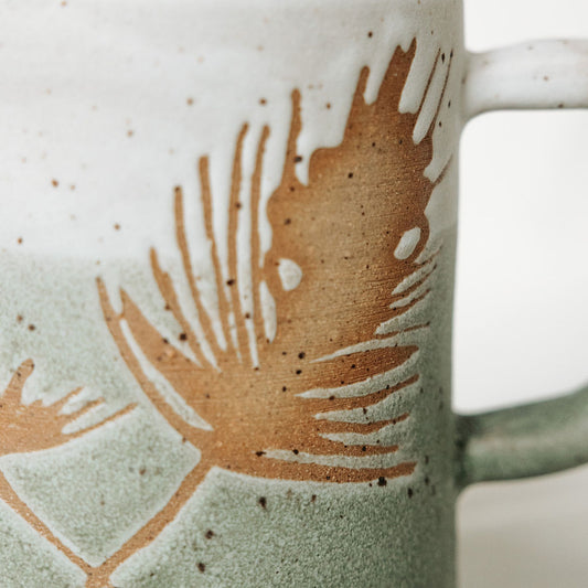 Winter Pine Boughs Mug in Black, Deep Evergreen, and Sand and Sage Glaze