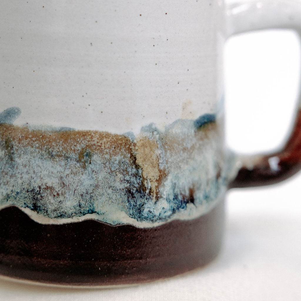 White, brown, and blue mug with local Whitemouth clay