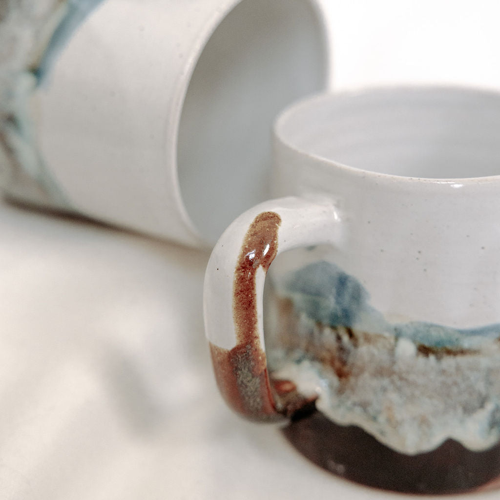 White, brown, and blue mug with local Whitemouth clay