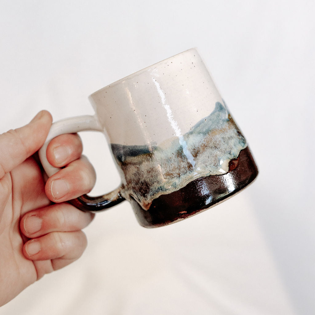 White, brown, and blue mug with local Whitemouth clay